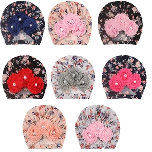 Set of eight floral print baby turbans with decorative fabric flowers and pearls