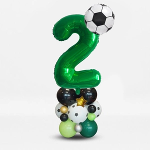 Detail of soccer themed balloon stand with green number 2 and football foil balloon