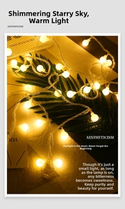 Aesthetic warm white LED globe string lights decorating leaves for a cozy outdoor ambiance