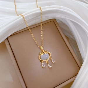 Elegant gold-plated cat eye lock necklace featuring sparkling zircon crystals on fabric