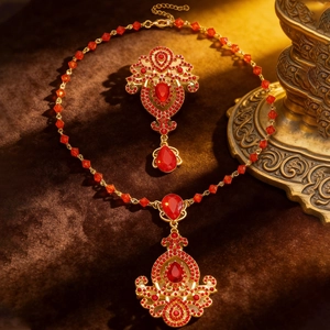 Detailed macro view of vintage red crystal pendant on a brown velvet surface