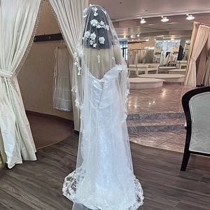 Detail of bridal veil featuring 3D handmade flowers, scattered pearls and vine lace edges