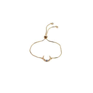 Detail of adjustable gold moon bracelet with colorful pavé cubic zirconia evil eye charms