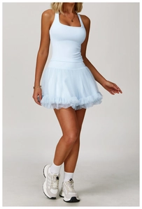 Detail of light blue racerback sports dress with layered tulle skirt and tight fit