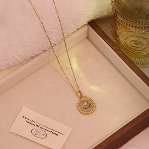 Vintage gold rose pendant necklace with small pearl in a wooden jewelry box