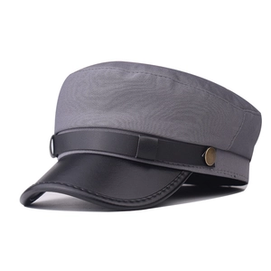 Detail of grey cotton flat cap with black leather brim and golden metal buckle side view