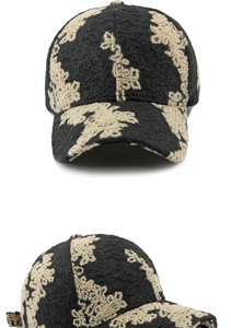 Detailed view of ethnic jacquard baseball cap with floral embroidery and textured fabric