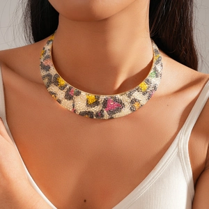 Dettaglio macro di girocollo leopardato con strass colorati e placcatura in oro di lusso