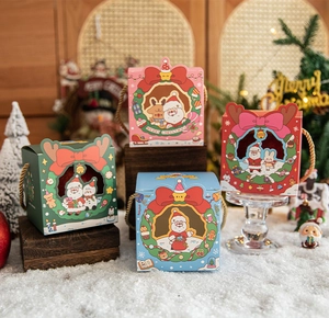 Close-up of festive Christmas gift boxes with hollow windows and woven handles in scenic decor