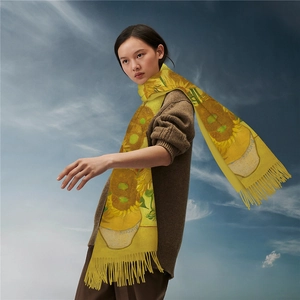 Close-up of Van Gogh sunflower print and fine fringe on yellow cashmere-feel scarf