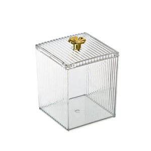 Transparent acrylic storage box with vertical stripes and a golden flower handle knob