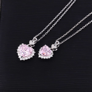 Detail of pink heart-shaped crystal pendant necklace with sparkling moissanite halo