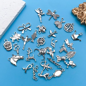 Assorted silver alloy charms featuring animals and symbols on a blue decorative background