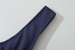 Close-up of deep blue tank dress straps showing fabric texture and double stitching detail