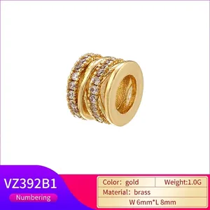 Golden multi-layer hollow spacer bead in brass with sparkling zircon crystals, 8x6mm