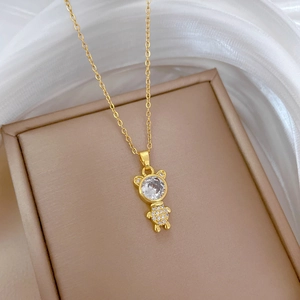 Elegant gold teddy bear necklace featuring a large crystal head and pavé crystal body detail
