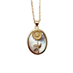 Elegant gold oval necklace with natural shell flower pendant and mother of pearl detail