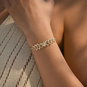 Detail of 18K gold plated bracelet with marquise and baguette zircons on a wrist