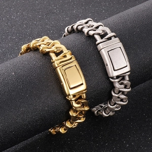 Detail of heavy industrial Cuban link bracelets in polished gold and antique silver finish