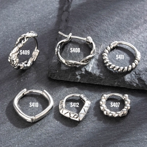 Vintage titanium steel hoop earrings set with braided and textured designs in silver
