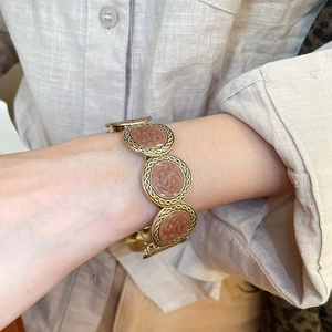 Detailed close-up of vintage gold floral reliefs on the leopard print elastic bracelet