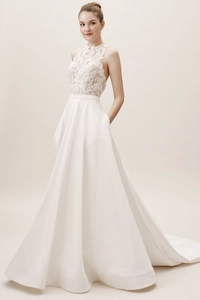 Detail of elegant white halter lace bodice and smooth satin skirt with side pockets
