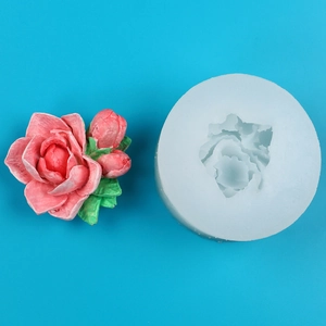 Detailed view of white silicone mold and finished pink rose flower with green leaves