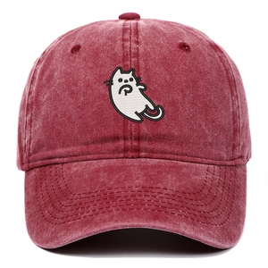Close-up of white cartoon cat embroidery on washed vintage burgundy baseball cap