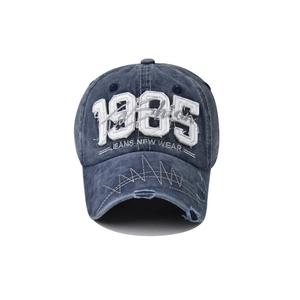 Close-up of 1985 embroidery and vintage distressed details on cotton baseball cap