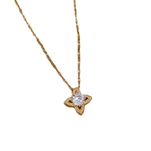 Golden clover pendant necklace with zircon crystals and O-chain on white background