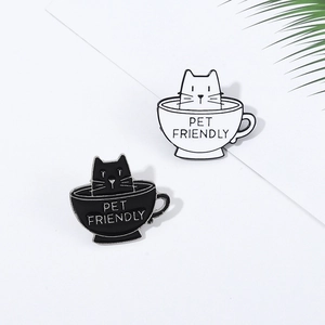 Enamel cat pins in black and white featuring coffee cup design and PET FRIENDLY text