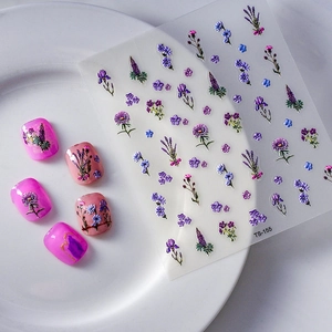 5D floral nail stickers with embossed lavender and daisy patterns on a marble background