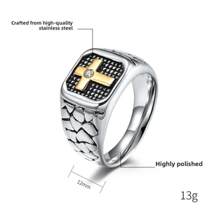 Detailed macro view of 12mm wide stainless steel ring with golden cross and stone inlay