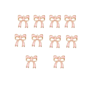 Detailed view of 10 pink enamel bow pendants with gold frames for DIY jewelry
