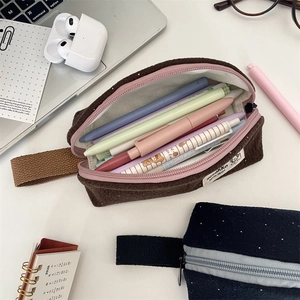 Macro view of corduroy pencil cases with large capacity and woven side label