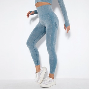 Detail of high-waist seamless yoga leggings with ribbed side panels in acid wash blue