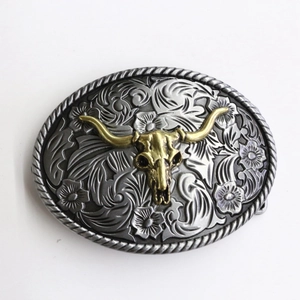 Western cowboy belt buckle featuring gold bull skull with vintage floral relief
