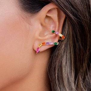 Detailed close-up of rainbow gemstone snake earrings with gold plating on ear