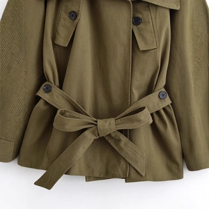 Army green military jacket with sailor collar and waist belt detail in a close-up shot