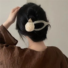 Dettaglio dell'elegante forcina per capelli con rosa crema per acconciature raffinate