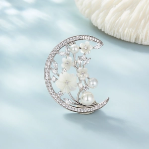 Elegant S925 silver crescent brooch with floral pearls and cubic zirconia on blue background