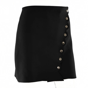 Detailed view of the wavy hemline and metallic buttons on a black faux suede mini skirt