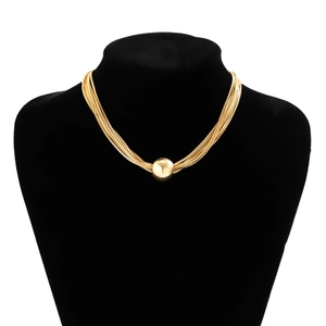 Detail of layered gold hip-hop chain necklace with a large round bead pendant on a black bust