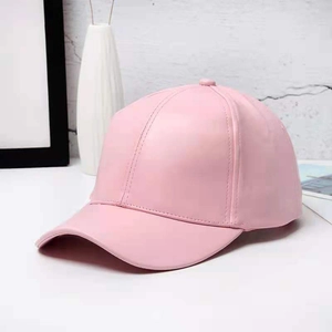 Pastel pink PU leather baseball cap in a minimalist setting for a trendy casual style