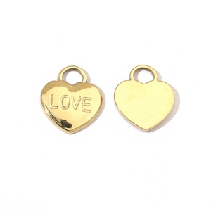 Detailed view of heart-shaped gold pendants with LOVE engraving and polished back