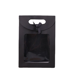 Elegant black gift bag featuring a transparent window and a decorative black ribbon bow