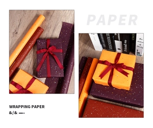 Detail of premium orange and purple wrapping paper with gold foil glitter and gift boxes