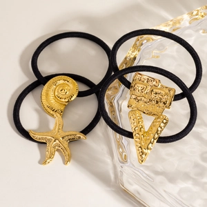 Detail of black elastic hair ties with gold sea shell and starfish metal pendants