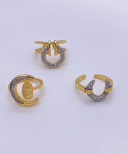 Detail of 18K gold plated rings with geometric shapes and pave zircon settings