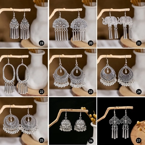 Collection of vintage silver boho ethnic earrings with metallic tassels and ornate designs